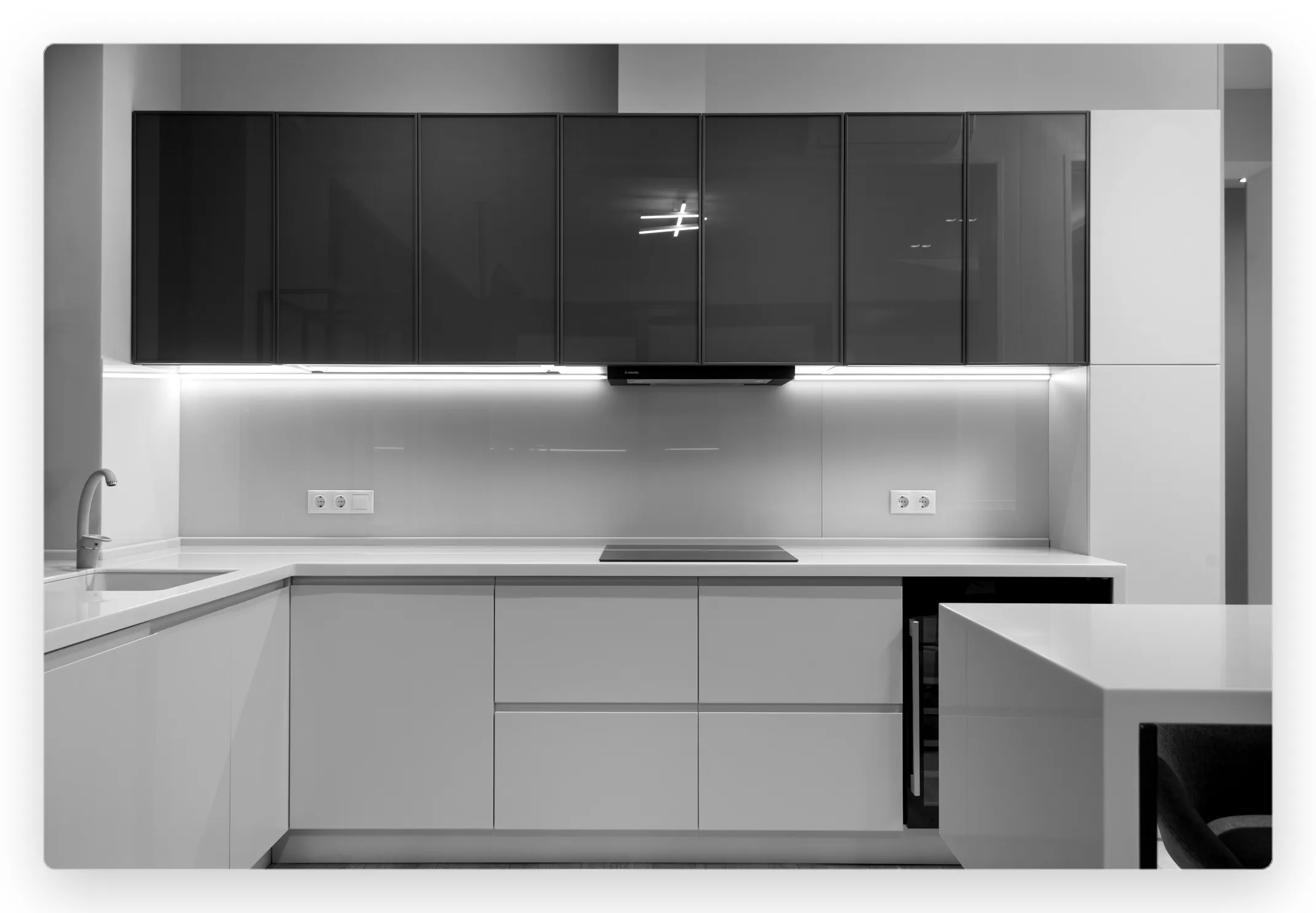Modern two-tone kitchen with dark upper cabinets and white base units