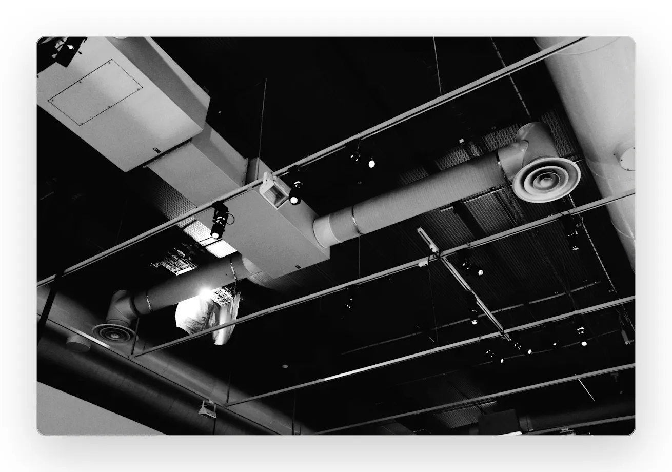 Exposed ductwork and mechanical services in a commercial ceiling