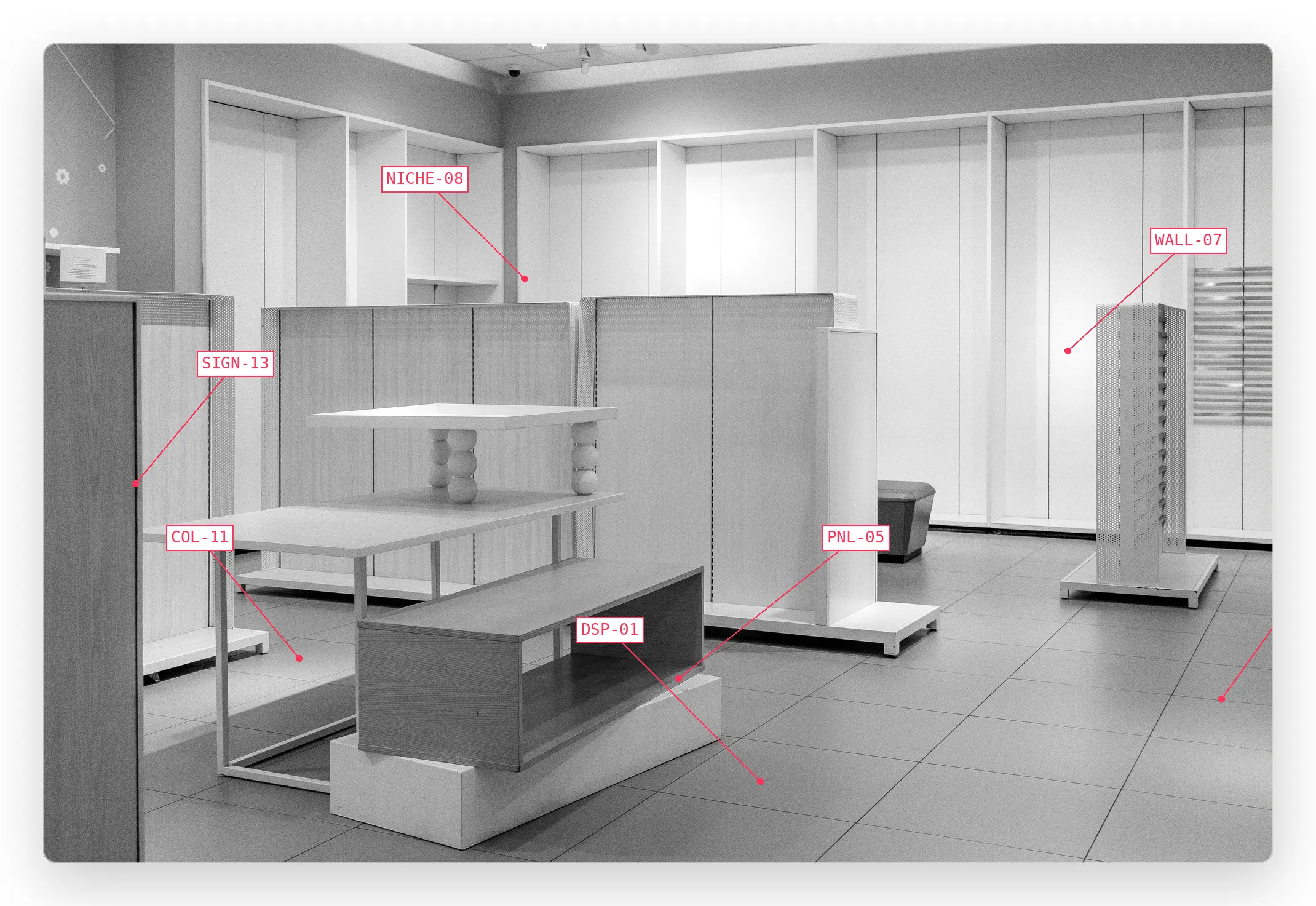 An empty retail interior with fixtures labeled by code